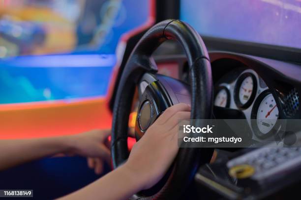 Happy Boy Playingcar Racing Video Game Stock Photo - Download Image Now - Amusement Arcade, Driving, Simulator