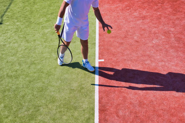 istock Confident mature man playing tennis on sunny day 1168138745