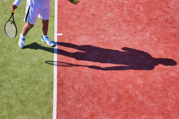 istock Confident mature man playing tennis on sunny day 1168140173