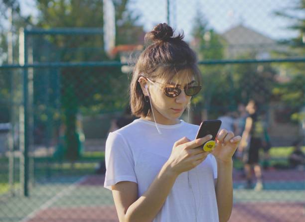 istock Listening music in public park 1168140366