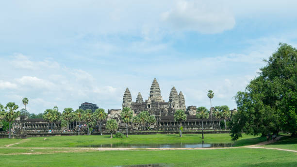 belle photo de paysage du temple de bayon dans la ville d'ankgor thom entourée par une belle forêt verte et sous un ciel bleu clair au cambodge - patrimoine mondial par l'unesco en 1992 - clear sky asia sky old ruin photos et images de collection