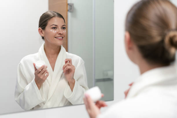 istock Woman holding cream in hands, standing at bathroom 1168144669
