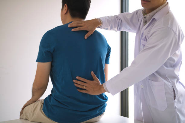 istock Physical therapists are using hands to check the back of the patient. 1168146515