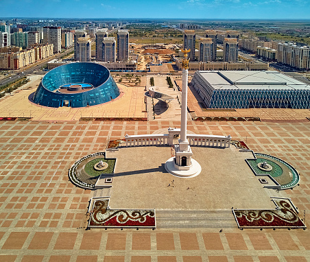 Beautiful panoramic aerial drone view to Nursultan (Astana) city center with skyscrapers, Monument Kazakh Eli, Shabyt Palace and Hazrat Sultan Mosque, Astana (Nur-Sultan or Nursultan), Kazakhstan (Qazaqstan)
