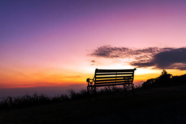 istock Silhouette of bench against twilight sky over a mountain with copy space. 1168148787