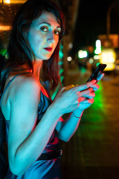 istock Pretty woman using smart phone at the street 1168149180