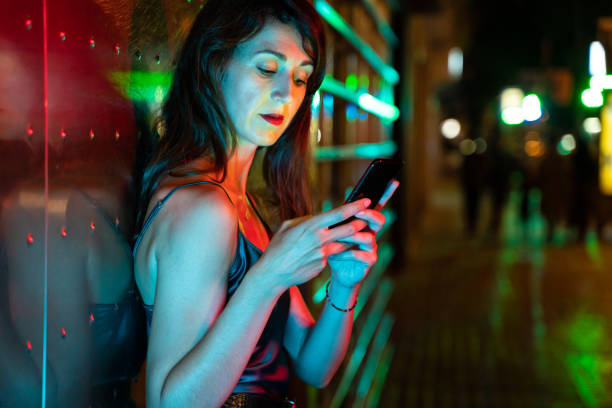 istock Pretty woman using smart phone at the street 1168149181