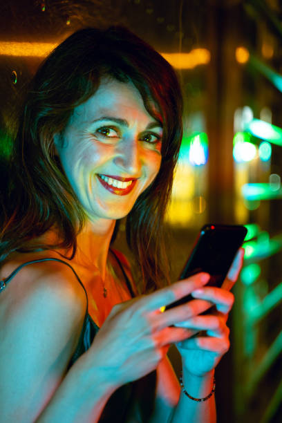 istock Pretty woman using smart phone at the street 1168149182