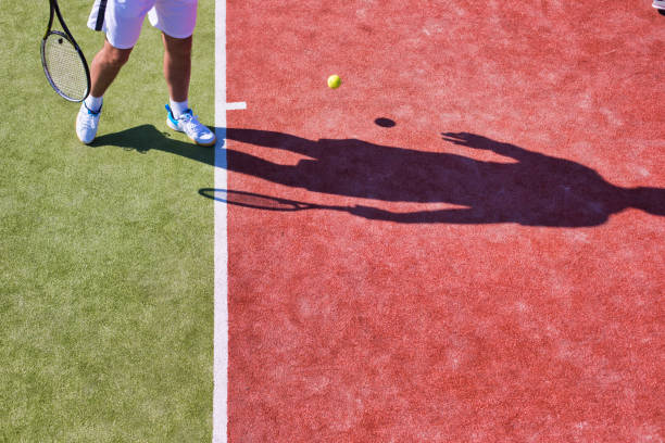 istock Confident mature man playing tennis on sunny day 1168149246