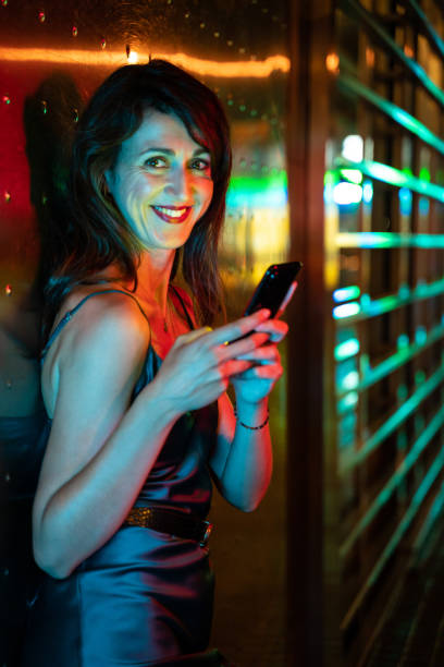 istock Pretty woman using smart phone at the street 1168149631