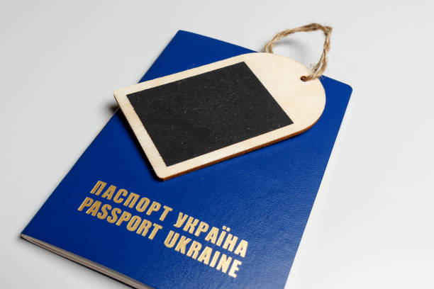 istock Tag with a blue passport on a white table, close-up, mockup 1168153395