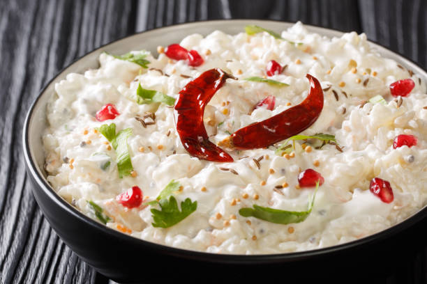 istock Thayir Saadam (Curd Rice) Recipe where  steamed rice and plain curd or with additional tempering of spices closeup in a plate. horizontal 1168154776