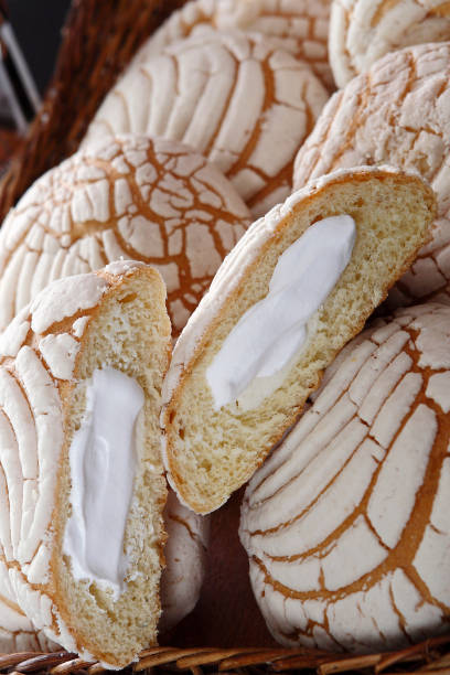 istock Shells stuffed with cream cheese. The shells are a traditional sweet bread from Mexico. The shell is a variety of Mexican sweet bread. It is named for its shape similar to the shell. It contains a layer, called pasta, based on sugar, butter, and flour on 1168155428