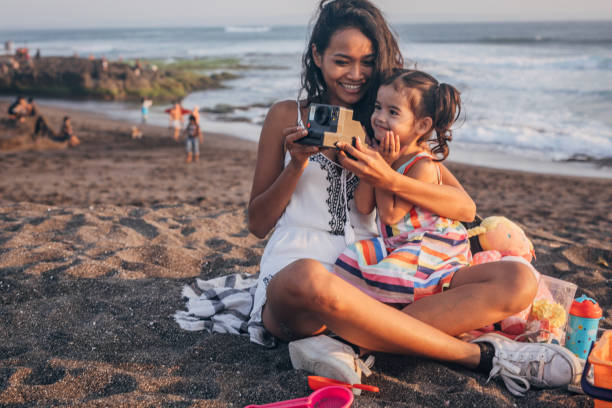 istock Mother and little daughter on the beach 1168159830