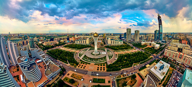 Beautiful panoramic aerial drone view to Nursultan (Astana) city center with skyscrapers and Baiterek Tower - symbol of Kazakh people freedom - The monument represents the idea of the Kazakh people about the universe. According to legend, Baiterek is the tree of life, to which the sacred bird Samruk aspires