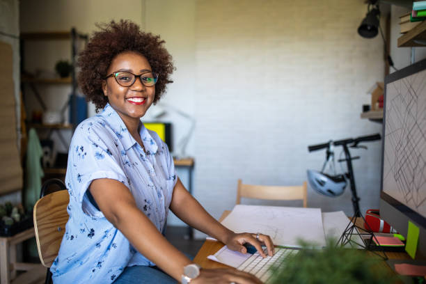 istock Smiling Afro female graphic designer at work 1168160925