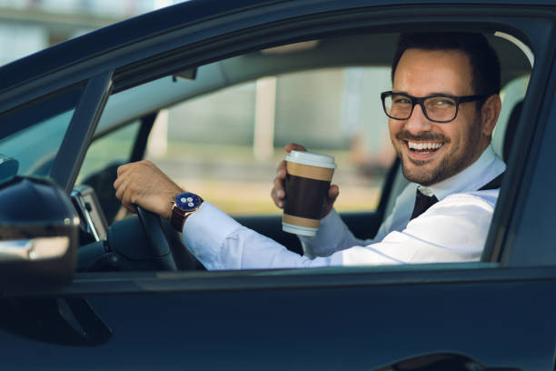 istock Businessman looking at camera through the car 1168161103