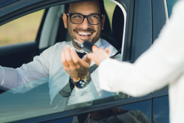 istock Businessman receiving new car key 1168161755