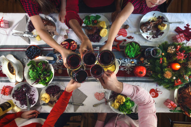 istock family clinking glasses over christmas table 1168165173