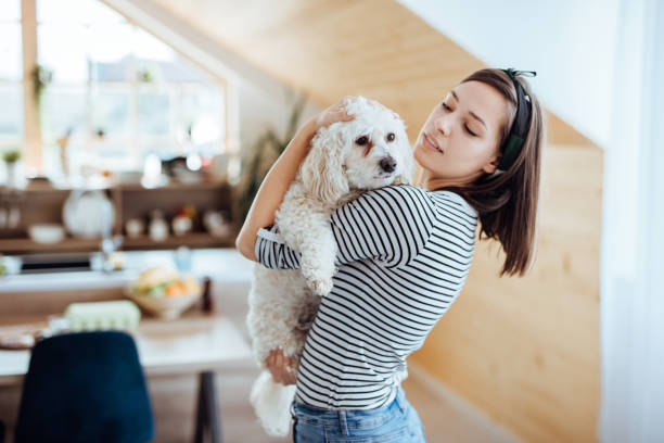 istock Beautiful woman embracing her dog 1168166494