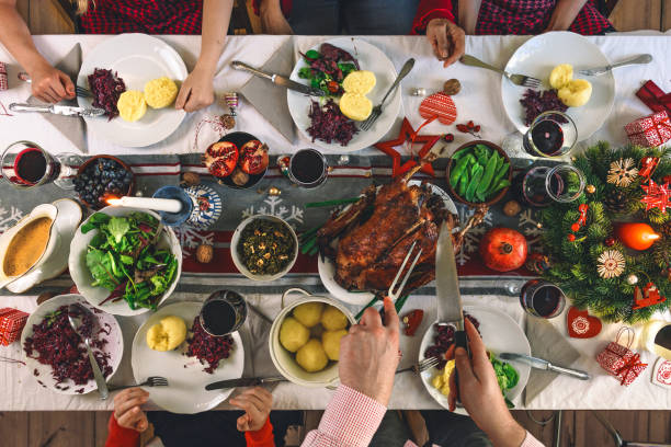 istock family sitting around christmas table 1168166528