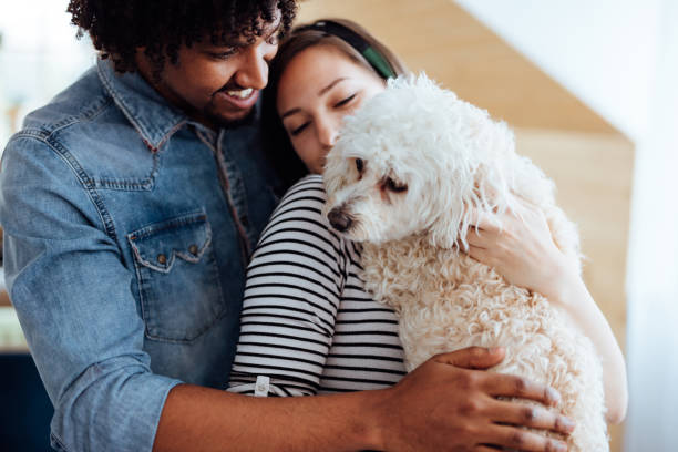 istock Happy couple playing with their dog 1168166573