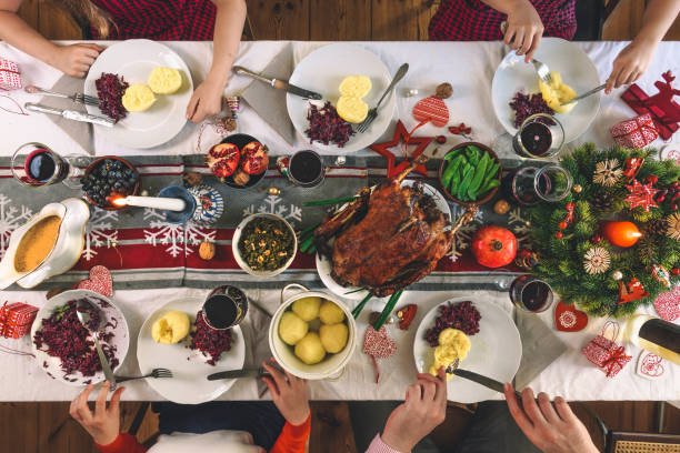 istock family sitting around christmas table 1168166692