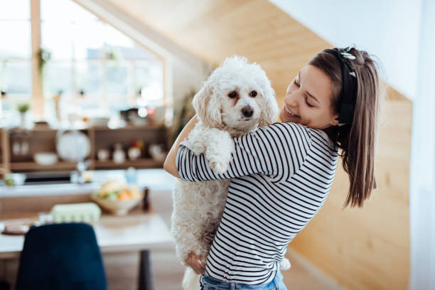 istock Beautiful woman embracing her dog 1168166820