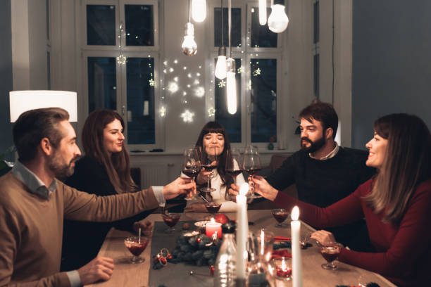 istock friends clinking wine glasses at christmas table 1168167409