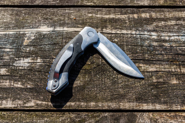 istock Folding knife on the rustic wooden background 1168167550