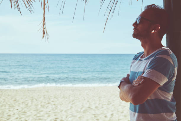 istock Attractive man enjoying on the tropical beach. Summer concept. 1168170115