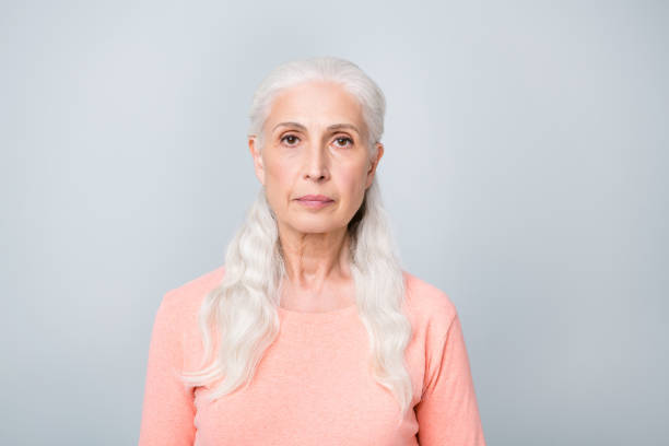 istock Close-up photo of serious focused attractive old lady wearing simple peach colored pullover isolated grey background 1168175166