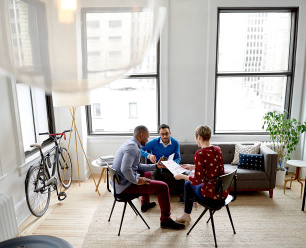 istock Multi-ethnic team of creative millenials collaborating on a brainstorm project 1168175808