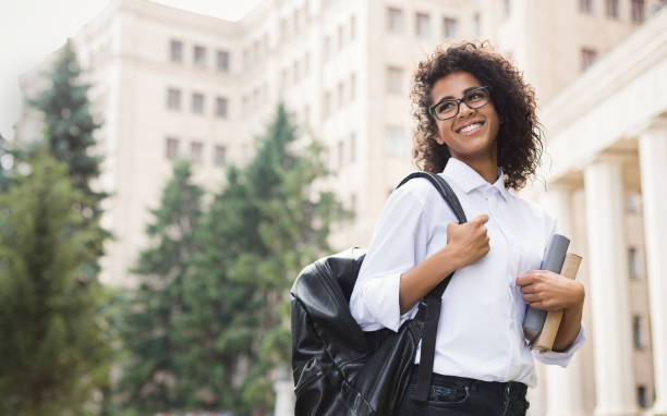 istock Smiling afro student with backpack and books outdoor 1168176728