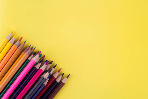 istock Colored pencils laid out on a yellow background, school supplies 1168178332