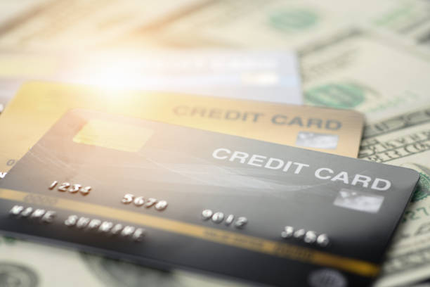 istock close up and selective focused of credit card on banknote background 1168178397