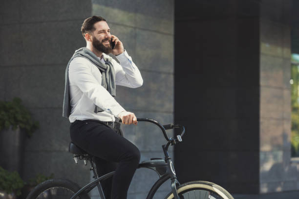 istock Businessman stop bicycle to talk on phone 1168178754