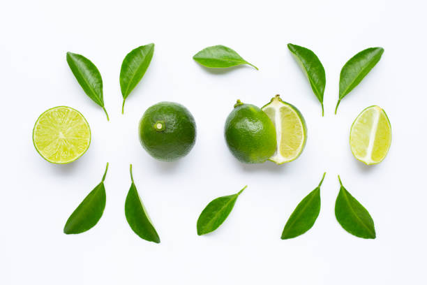 istock Fresh limes with leaves isolated on white 1168178919