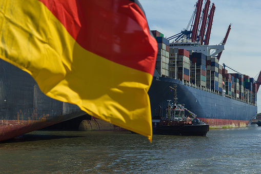 Container ship at container terminal Germany flag export free trade economy