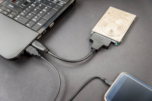 istock hdd 2.5 internal hard drive disk connected to laptop and smartphone via sata usb cable closeup view 1168182463