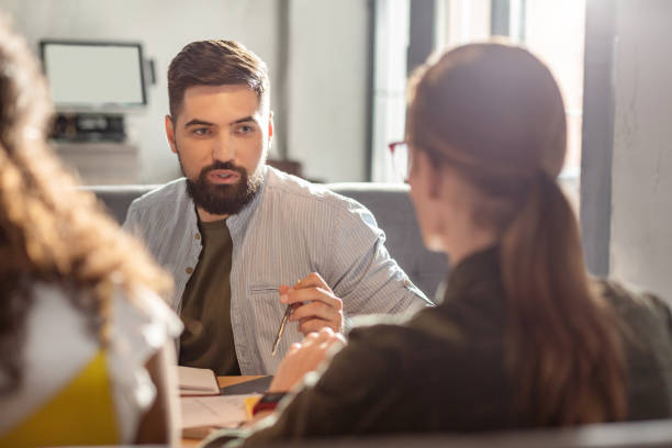 istock Pleasant bearded man looking at his colleague 1168184230