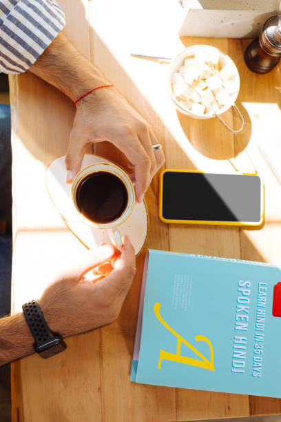 istock Top view of a coffee cup in male hands 1168184367