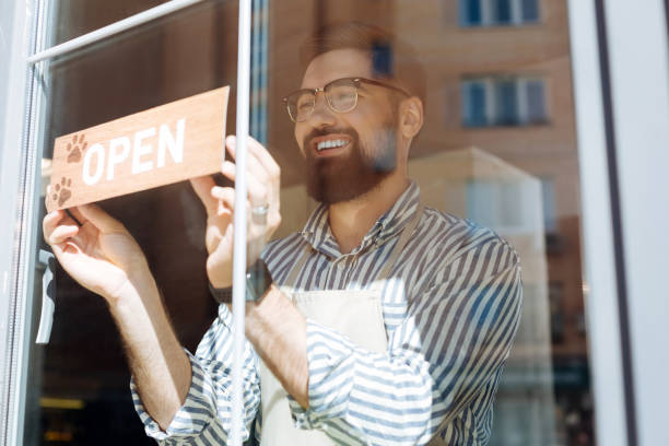 istock Joyful delighted man putting the sign on the window 1168184537