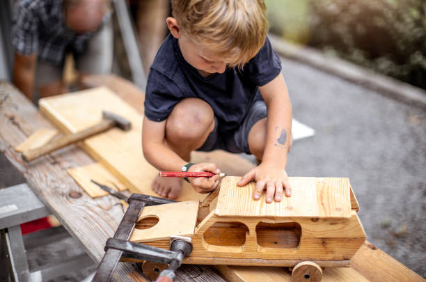 istock Young Child Crafting a Car From Wood 1168185131