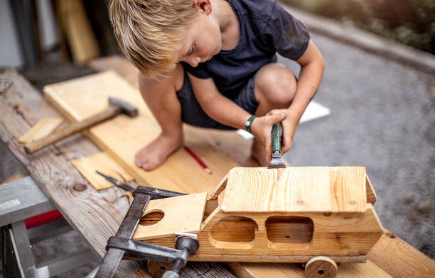 istock Young Child Crafting a Car From Wood 1168185171
