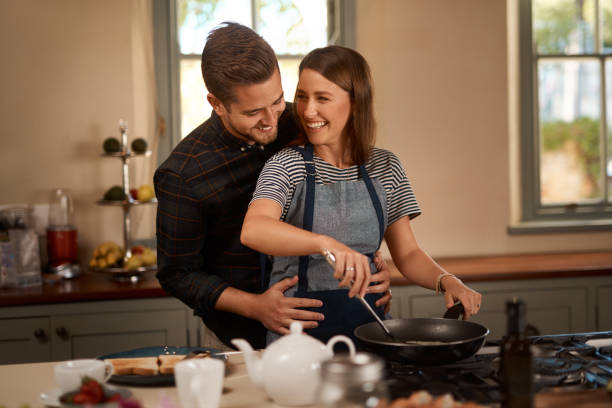 Cropped shot of an affectionate couple standing together in the kitchen at home