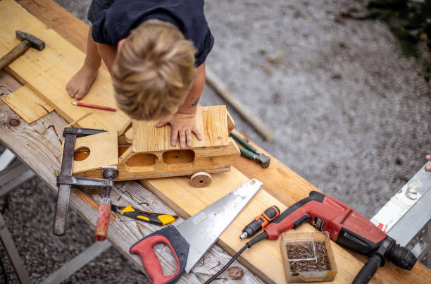 istock Young Child Crafting a Car From Wood 1168186674