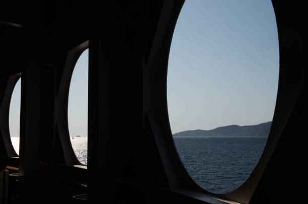 istock Three Port Holes with land in distance 1168187280