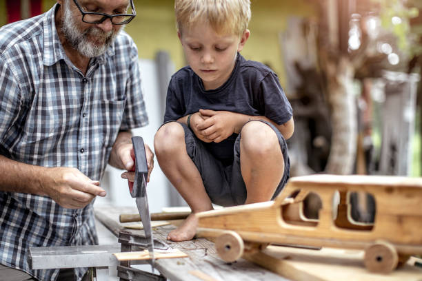 istock Grandfather and Grandson Making a Car From Wood 1168189251