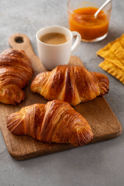istock Freshly baked croissants and coffee cup on grey table. Copy space. 1168190871